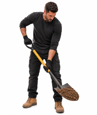 Man holding a shovel to create an off-street driveway and drainage systme