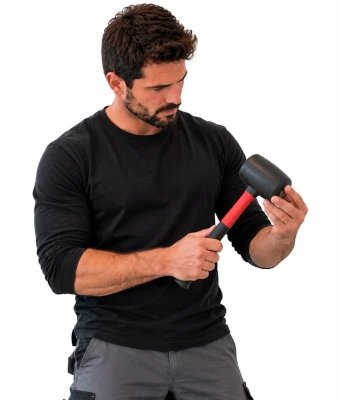 Man holding rubber mallet assist in installing a floating engineered wood floor