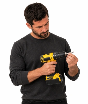 Man holding a drill to assist in laying timber decking