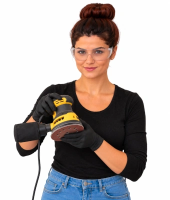 Lady holding orbital sander to smooth edges when making rolling under-bed storage drawers