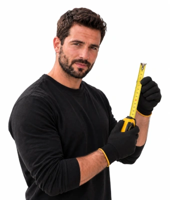 Man holding a measuring tape to assist in mounting a smart thermostat and hide cables