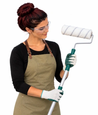 Women holding a paint brush to paint an exterior garden boundary wall