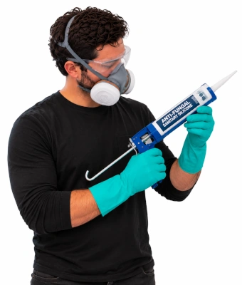 Man with sealant to kill and prevent stubborn bathroom mould
