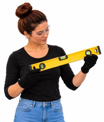 Woman holding a level, how to hide your wheelie bins with a timber screen
