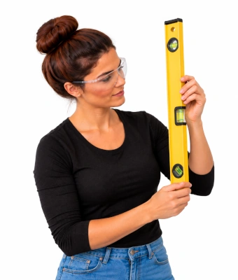 Woman holding a level to help with upgrading your wardrobe with internal organisers
