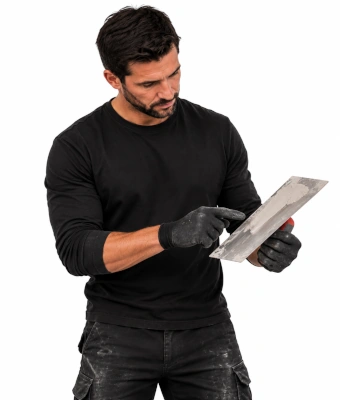 holding a plasterer's finishing trowel to flatten uneven floors when pouring self-levelling compount