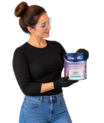 Lady holding a can of paint to refresh kids bedroom with new dulux easycare disney paint range