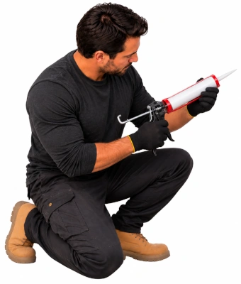 Man holding a caulking gun to weatherproof and lock garage doors securely